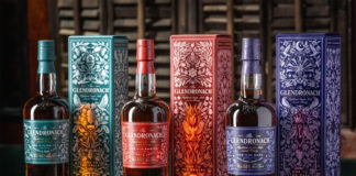 Bottles of The Glendronach The Master's Anthology range stand next to the outer packaging with Ode to The Valley, Ode to The Embers and Ode to The Dark.