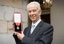 Sir Jim Walker accepting his knighthood from the King in 2022.