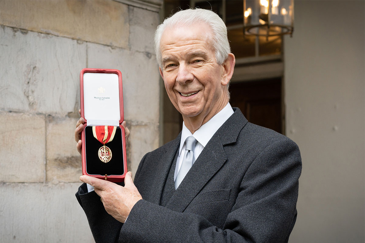 Sir Jim Walker accepting his knighthood from the King in 2022.