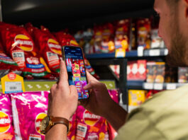 Jisp enhances its Scan & Save loyalty scheme A person uses the Jisp Scan & Save feature on his phone to scan products in a store.
