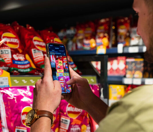 Jisp enhances its Scan & Save loyalty scheme A person uses the Jisp Scan & Save feature on his phone to scan products in a store.