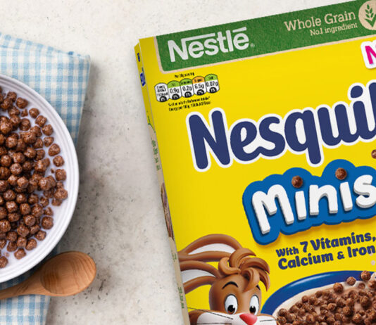 Nesquik rolls out some Minis fun A cereal box of Nesquik Minis sits on table with a bowl filled with the cereal and a spoon next to the bowl.