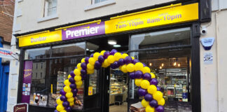 Front entrance to Premier Dunbar with a balloon arch outside the front door made with yellow and purple balloons.