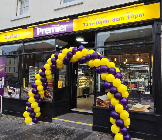 Premier opens up in Dunbar Front entrance to Premier Dunbar with a balloon arch outside the front door made with yellow and purple balloons.