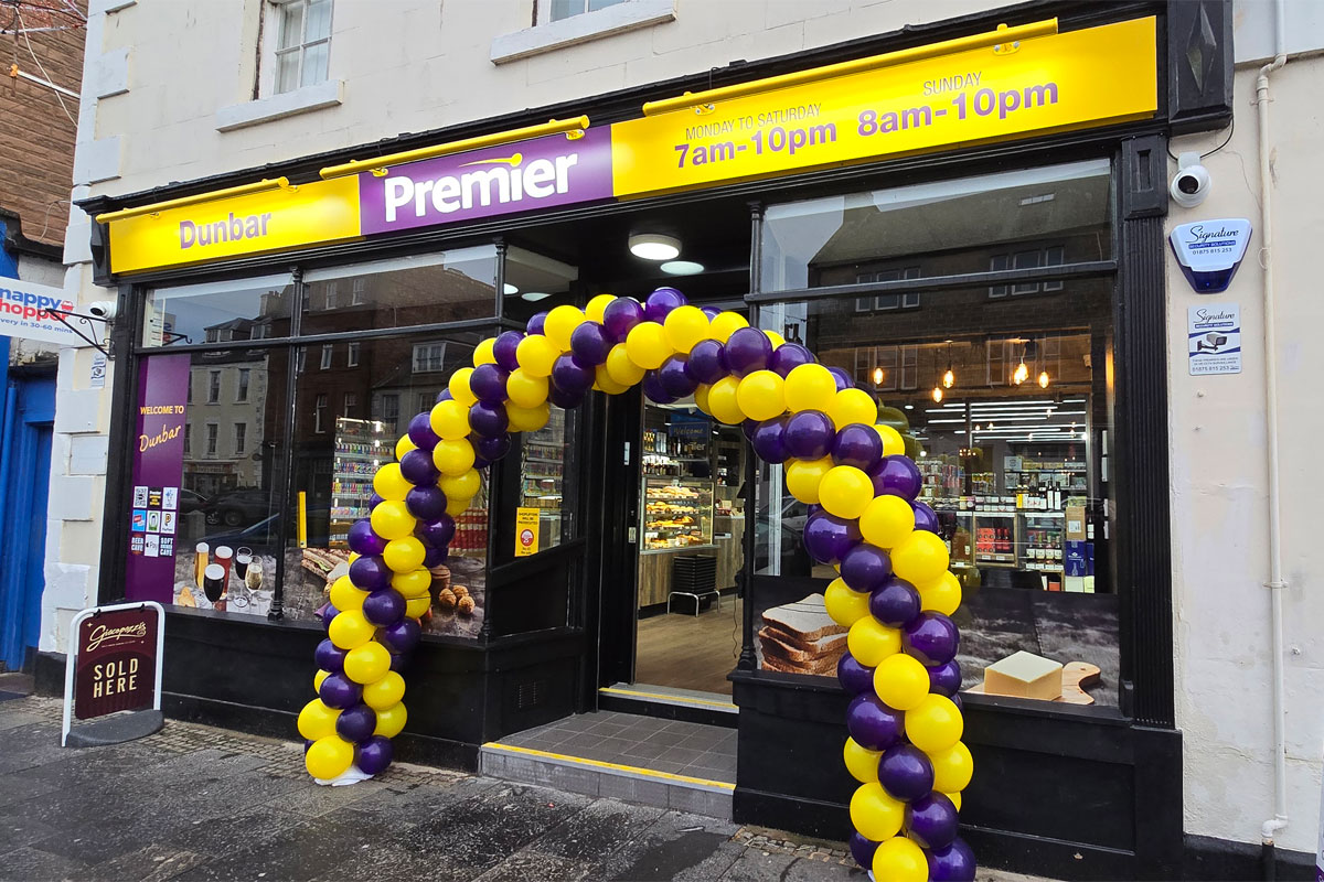 Front entrance to Premier Dunbar with a balloon arch outside the front door made with yellow and purple balloons.