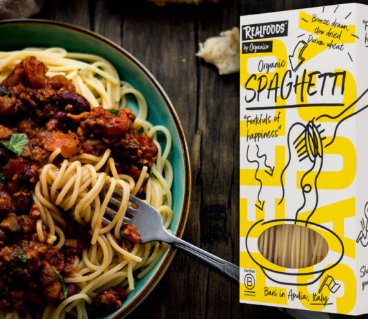Realfoods offers a pasta occasion for National Spaghetti Day A packet of Realfoods by Oraganico Organic Spaghetti is placed on top of an image of a bowl of spaghetti bolognese.