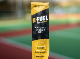 Scottish Bee launches new B-Fuel honey sachets A packet of Scottish Bee B-Gel is held up against a blurred out field in the background.