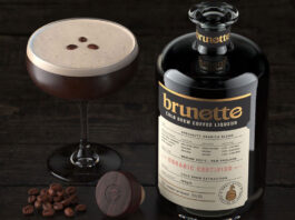 A bottle of Brunette Coffee Liqueur stands next to an Espresso Martini cocktail serve with coffee beans between the two.