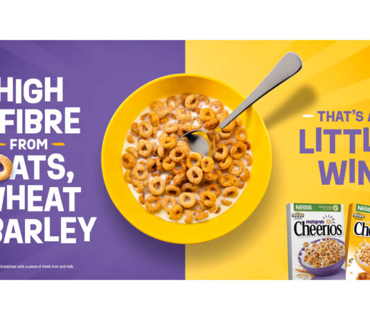 Cheerios launches new TV campaign Advert for Cheerios TV campaign with a bowl of the cereal in the middle of a purple and yellow colour with the text to the left reading "High in Fibre from Oats, Wheat and Barley" with the text on the right reading "That's a little win" with boxes of Cheerios and Honey Cheerios beneath this text.