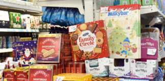 A selection of biscuits and chocolates on promotion in a store during the Christmas period.