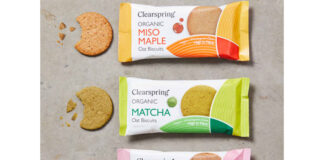 Packs of Clearspring Oat Biscuits sit against a grey background including Miso Maple, Matcha and Sweet Date with the biscuits sitting outside the packet with bites taken out of them.