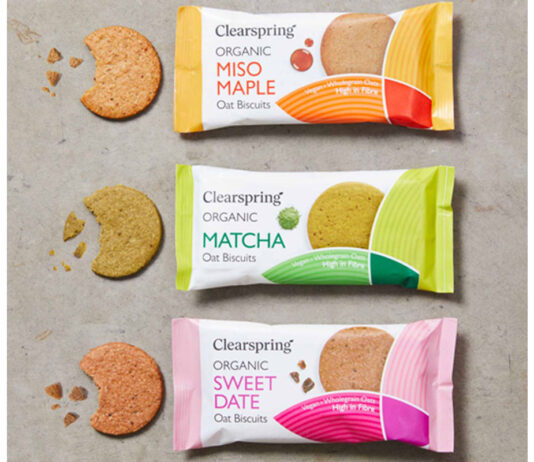 Clearspring launches international trio of oat biscuits Packs of Clearspring Oat Biscuits sit against a grey background including Miso Maple, Matcha and Sweet Date with the biscuits sitting outside the packet with bites taken out of them.