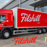 Filshill commits to success for landmark 150th anniversary year A JW FIlshill branded lorry sits in the wholesaler's depot with the Filshill 150 Years Logo.