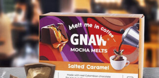 A pack of Gnaw Salted Caramel Mocha Melts sits on a table with one of the melts broken open with caramel pouring out next to the box.