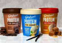 Packs of Graham's Protein Ice Creams sit on a countertop including Double Chocolate, Creamy Vanilla and Salted Caramel variants, with pieces of chocolate next to the Double Chocolate; vanilla pods next to the Creamy Vanilla; and pieces of caramel next to the Salted Caramel.