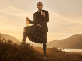 Harrison Ford takes star role in Glenmorangie campaign Hollywood actor Harrison Ford stands against a Highlands landscape during sunset in highland attire holding a bottle of Glenmorangie in one hand and a glass with the whisky inside it in the other.