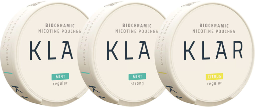 Pack shots of KLAR nicotine pouches including Mint Regular, Mint Strong and Citrus Regular.