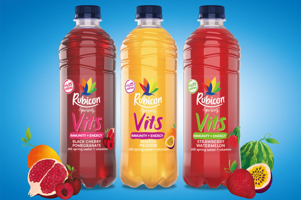 Bottles of Rubicon Spring Vits stand against a blue background with illustrations of fruit around the bottles.