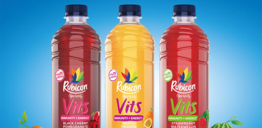 Bottles of Rubicon Spring Vits stand against a blue background with illustrations of fruit around the bottles.