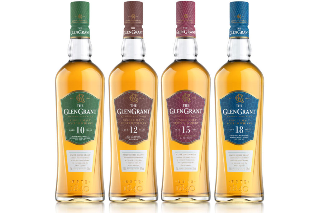 Four bottles of The Glen Grant whisky are lined up in a row including the 10 Year Old, 12 Year Old, 15 Year Old and 18 Year Old.