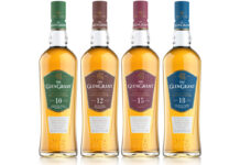 Four bottles of The Glen Grant whisky are lined up in a row including the 10 Year Old, 12 Year Old, 15 Year Old and 18 Year Old.