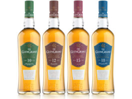 Four bottles of The Glen Grant whisky are lined up in a row including the 10 Year Old, 12 Year Old, 15 Year Old and 18 Year Old.