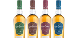 Four bottles of The Glen Grant whisky are lined up in a row including the 10 Year Old, 12 Year Old, 15 Year Old and 18 Year Old.