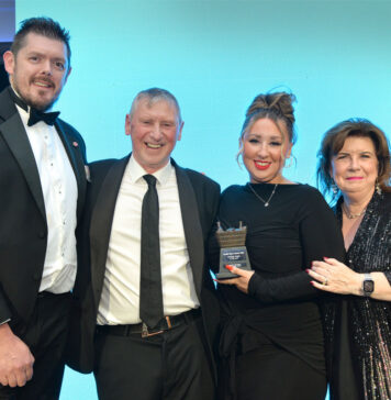 Tom Pook of Hovis, Dennis Williams and Sophi Williams of Premier Broadway Convenience store and actress Elaine C Smith stand on a stage at the Scottish Grocer Awards for the Community Store of the Year award win.