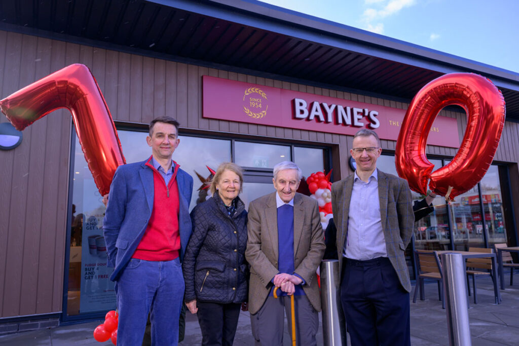 The Bayne's family stand outside the Perth Inverlamond Retail Park store with a 7 and 0 balloons to mark the family's 70 years of business.