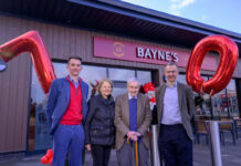 The Bayne's family stand outside the Perth Inverlamond Retail Park store with a 7 and 0 balloons to mark the family's 70 years of business.