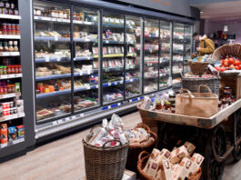 Concerning start to 2025 as inflation hits a 10-month high A range of chillers inside a store stocked up with meat products with a stand in the middle of the floor with some cupboard essentials on them.