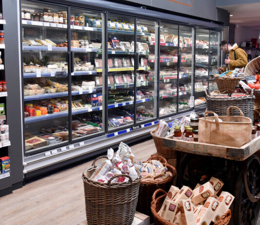Concerning start to 2025 as inflation hits a 10-month high A range of chillers inside a store stocked up with meat products with a stand in the middle of the floor with some cupboard essentials on them.