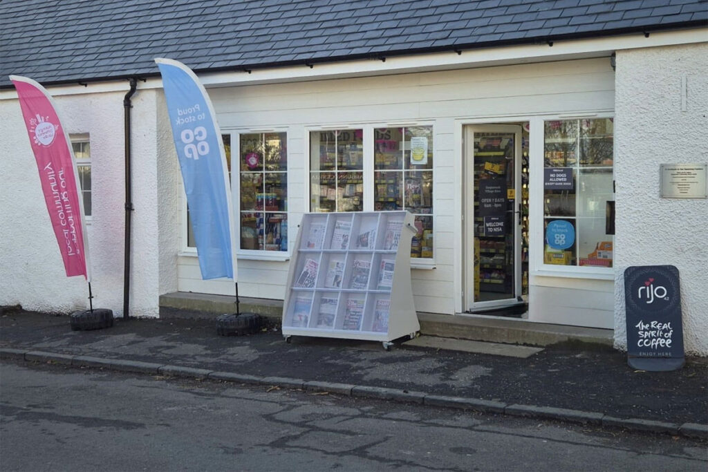 Store front of Nisa Cargunnock Village Store with flags flying for Co-op and Nisa's Making a Difference Locally charity.