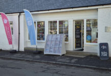 Store front of Nisa Cargunnock Village Store with flags flying for Co-op and Nisa's Making a Difference Locally charity.