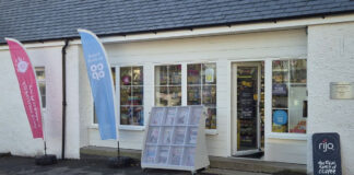Store front of Nisa Cargunnock Village Store with flags flying for Co-op and Nisa's Making a Difference Locally charity.