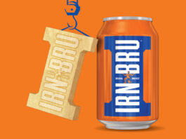 A can of Irn-Bru stands against an orange background with golden Irn-Bru Girder design hangs next to it, suspended by a drawing of a crane.