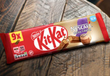 A multipack of KitKat Nescafé Mocha Flavour biscuits sit on a wooden table.