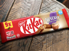 A multipack of KitKat Nescafé Mocha Flavour biscuits sit on a wooden table.