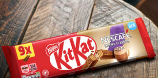 A multipack of KitKat Nescafé Mocha Flavour biscuits sit on a wooden table.