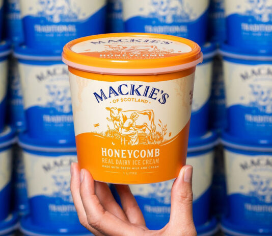 Mackie’s reports profits boost after wider UK distribution A hand holds up a tub of Mackie's of Scotland Honeycomb Ice Cream with tubs of Mackie's of Scotland Traditional lining the wall in the background.
