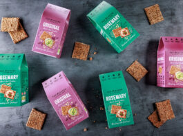 Pep & Lekker introduces functional cracker range Boxes of Pep & Lekker crackers along with the crackers themselves have been scattered across a grey background including the Original Mixed Seed Crackers and Rosemary Mixed Seed Crackers.