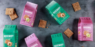 Boxes of Pep & Lekker crackers along with the crackers themselves have been scattered across a grey background including the Original Mixed Seed Crackers and Rosemary Mixed Seed Crackers.