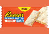 A pack shot of Reese's Peanut Butter White bar against an orange background.