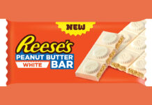 A pack shot of Reese's Peanut Butter White bar against an orange background.