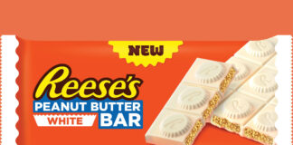 A pack shot of Reese's Peanut Butter White bar against an orange background.
