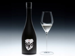 DrinksOne announces new partnership with Sake ONO A bottle of Sake ONO stands against a black and white background with a wine glass next to it containing the spirit.