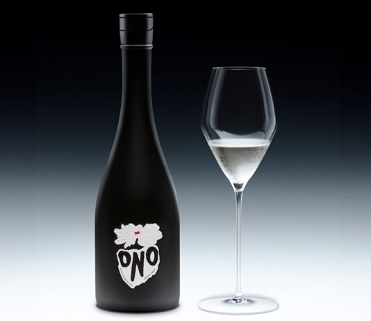 DrinksOne announces new partnership with Sake ONO A bottle of Sake ONO stands against a black and white background with a wine glass next to it containing the spirit.