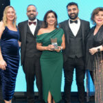Awards Profile – The Innovation Award Laura McDiarmid, Vikas Sud, Shamly Sud, Guna Sud and Elaine C Smith all stand on the Scottish Grocer Awards 2024 stage whilst Shamly holds a trophy for The Innovation Award 2024.