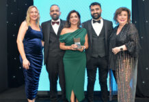 Laura McDiarmid, Vikas Sud, Shamly Sud, Guna Sud and Elaine C Smith all stand on the Scottish Grocer Awards 2024 stage whilst Shamly holds a trophy for The Innovation Award 2024.