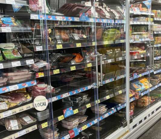 Win DoubleCool doors for your store’s chillers A range of chillers in a convenience store with a range of chilled foods inside with DoubleCool branded doors attached to the coolers.